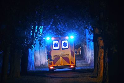 Rear view of ambulance on street at night