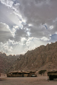 Scenic view of mountains against cloudy sky