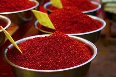 High angle view of red chili powder in bowls