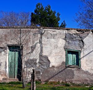 Exterior of old building against clear blue sky