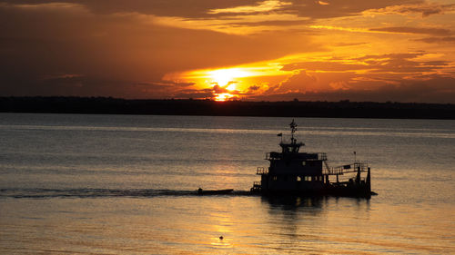 Sunset with a boat in amazon river