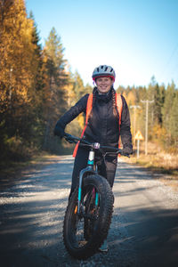 Man riding bicycle on road