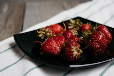 High angle view of strawberries in bowl on table