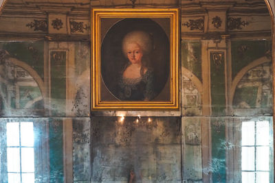 Portrait of man seen through glass window of building