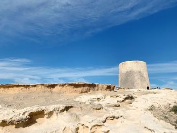 Low angle view of rock formation against sky