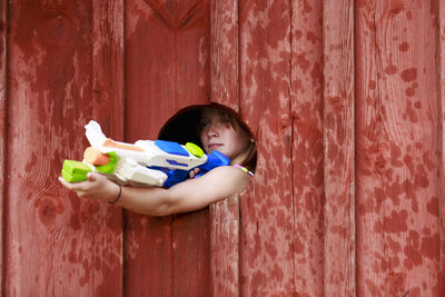 Girl aiming with plastic gun