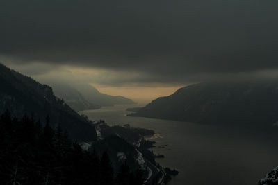 The columbia river winds through the columbia gorge at night.