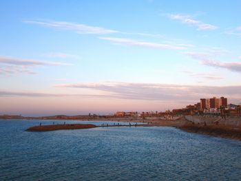 Scenic view of sea and buildings against sky