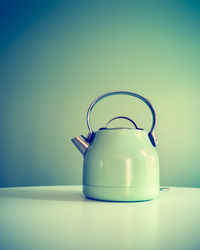 Close-up of wineglass on table against blue background