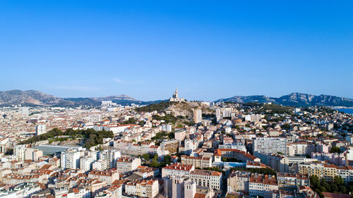 Cityscape against clear blue sky