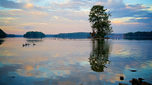 Scenic view of lake against sky at sunset