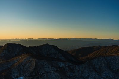 Scenic view of dramatic landscape against sky during sunset