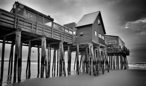 Low angle view of pier over sea against sky