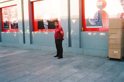 Full length of man standing on footpath