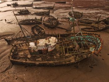 Abandoned boats moored in water