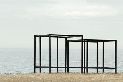 Lifeguard hut on beach against sky