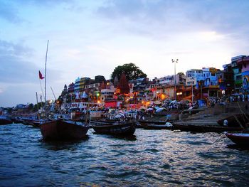 Boats in harbor with city in background
