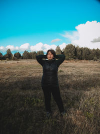 Full length of woman standing on field