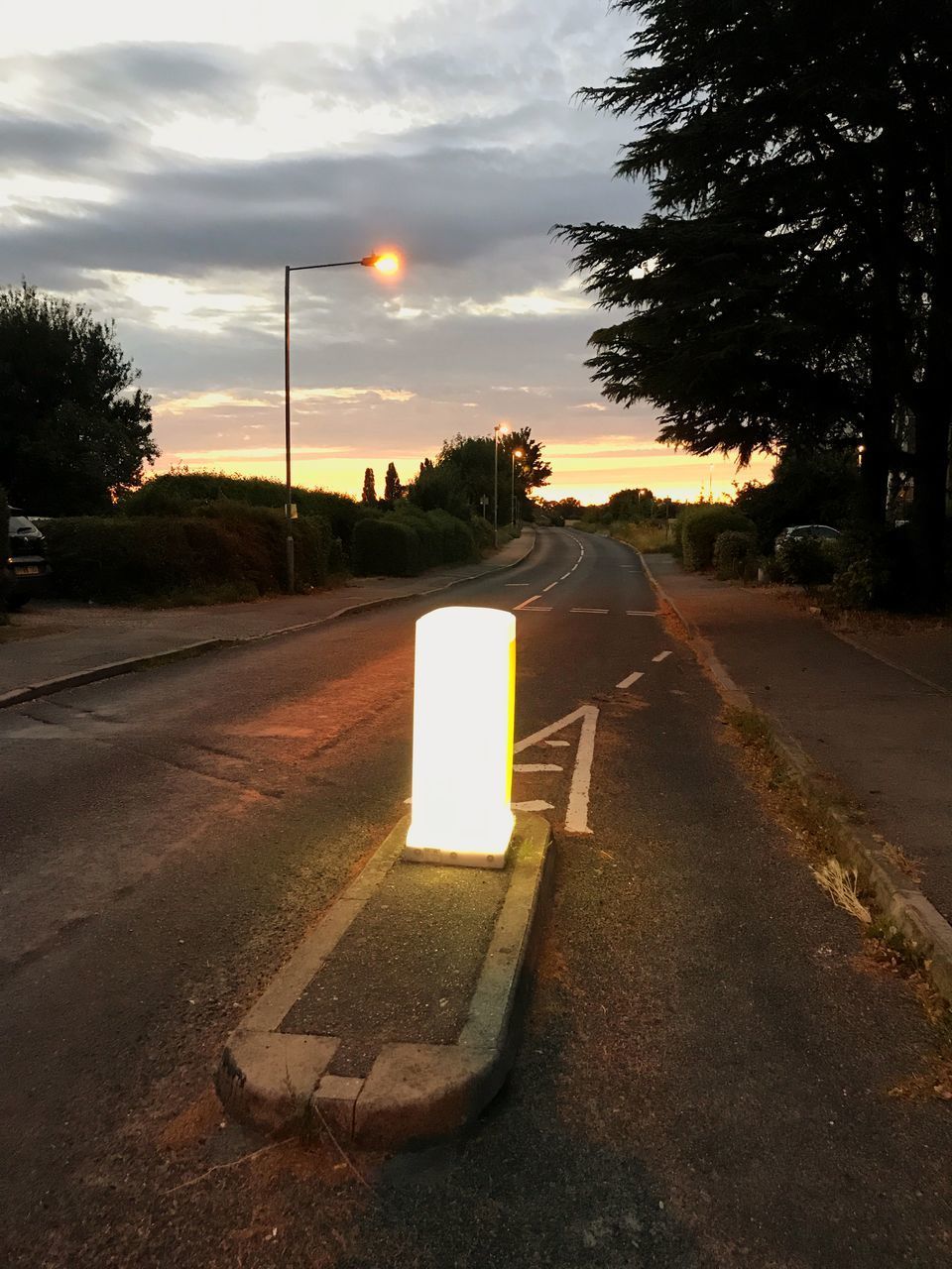 ROAD SIGN ON STREET AGAINST SKY