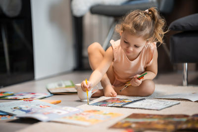 Side view of mother playing with toy blocks at home