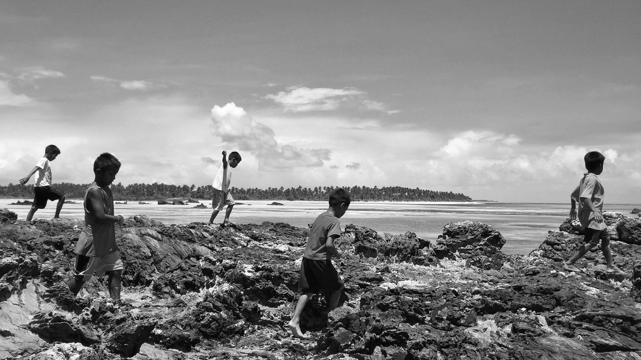 leisure activity, lifestyles, water, sky, full length, beach, men, sea, boys, rear view, standing, shore, childhood, person, girls, cloud - sky, togetherness, casual clothing