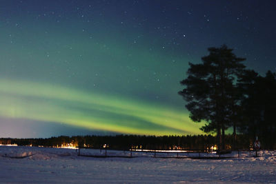 Scenic view of snowy landscape against sky at night