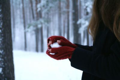 Close-up of woman with hand in snow