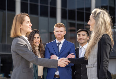 Business colleagues stacking hands