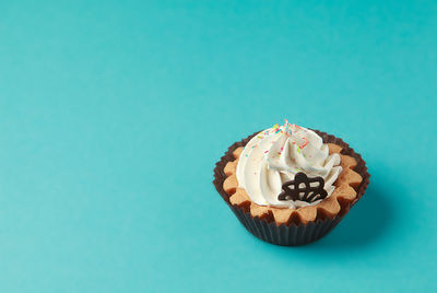 High angle view of cupcakes against blue background