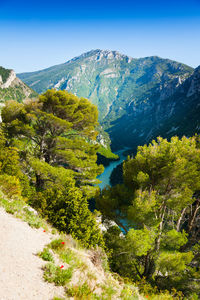 Scenic view of mountains against clear blue sky