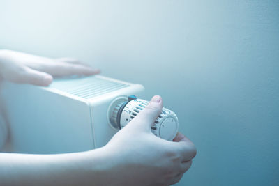 Cropped hand of woman holding thermometer