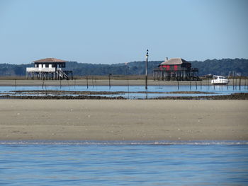 Lifeguard huts at beach against clear sky