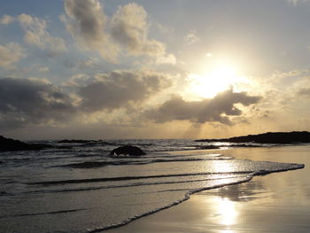 View of calm beach at sunset