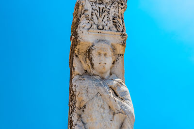 Low angle view of statue against blue sky