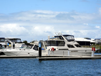 Ship moored at harbor against sky