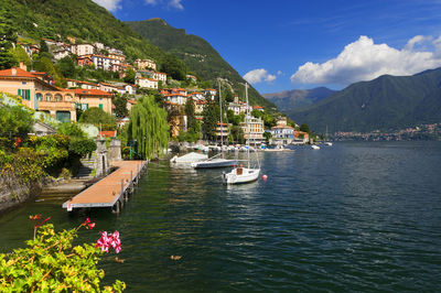 Boats in river against built structures