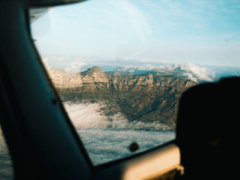 Scenic view of landscape seen through car window