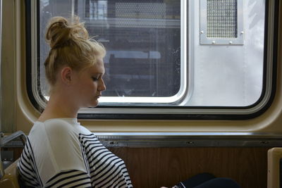 Profile view of woman traveling in train