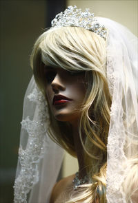 Close-up of woman wearing mask against blurred background