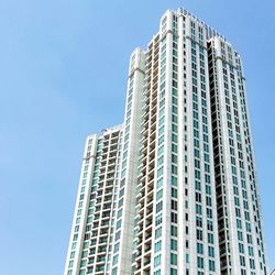 Low angle view of modern building against clear blue sky