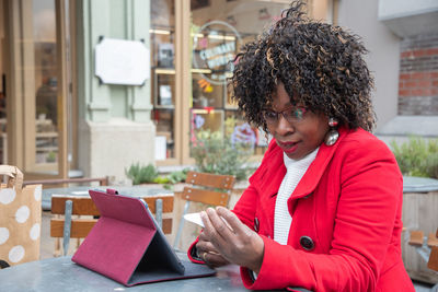 Young african american woman shocked after checking higher bill after shopping