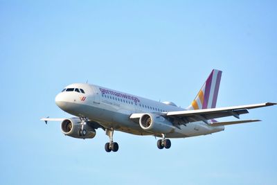 Airplane flying against clear blue sky