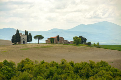 Scenic view of trees and buildings against sky