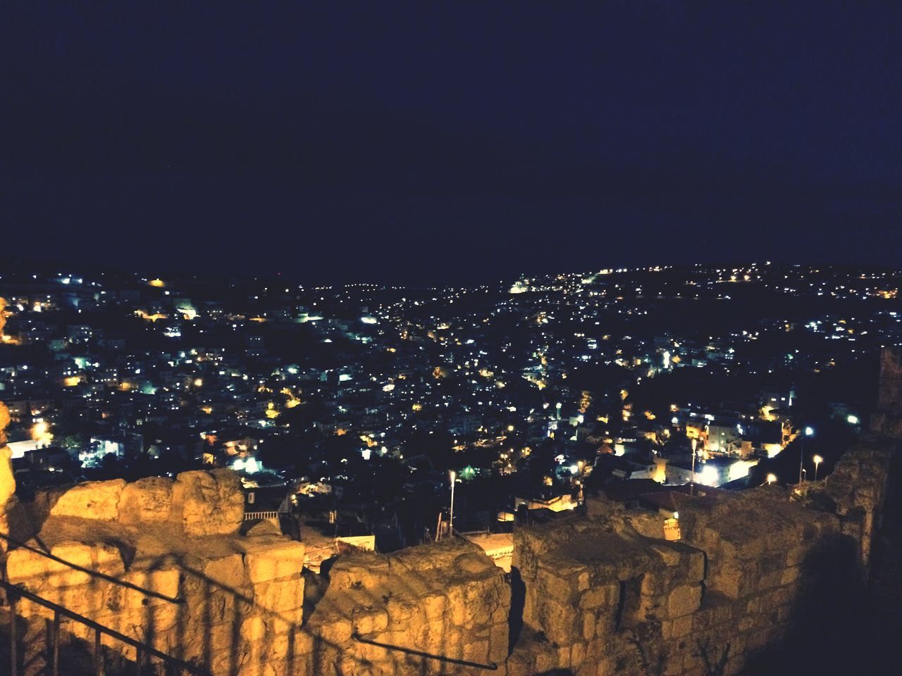 night, cityscape, illuminated, building exterior, architecture, built structure, city, crowded, high angle view, copy space, residential district, clear sky, residential building, residential structure, dark, aerial view, city life, sky, no people, community