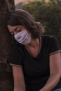 Portrait of beautiful young woman looking away outdoors