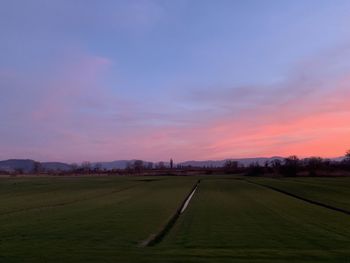 Scenic view of field against sky during sunset