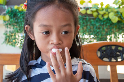 Portrait of cute girl holding food