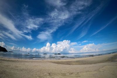 Panoramic view of beach against blue sky