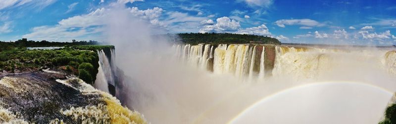 Panoramic view of waterfall against sky