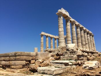 Low angle view of old ruins against clear blue sky